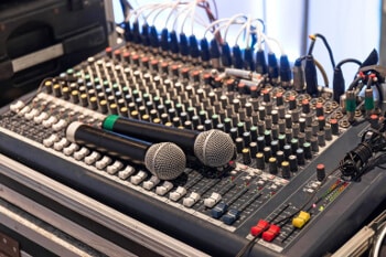 Two wireless microphone on sound mixer control panel